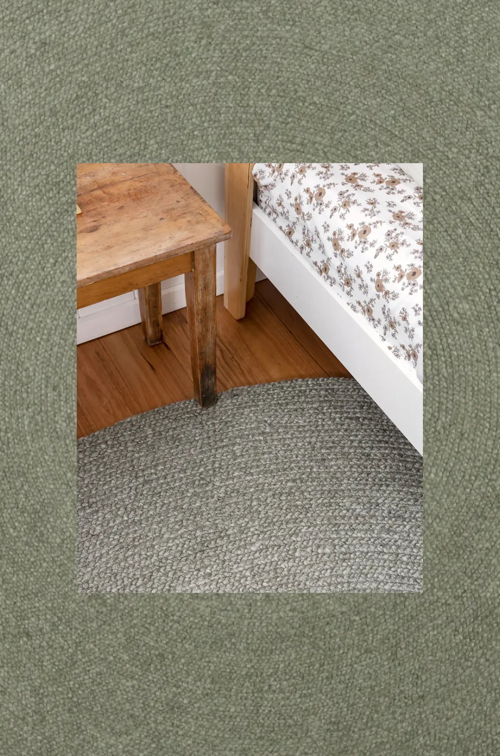 Wooden bench and bed with floral bedding on a textured green background